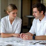 Two people discussing cake design.